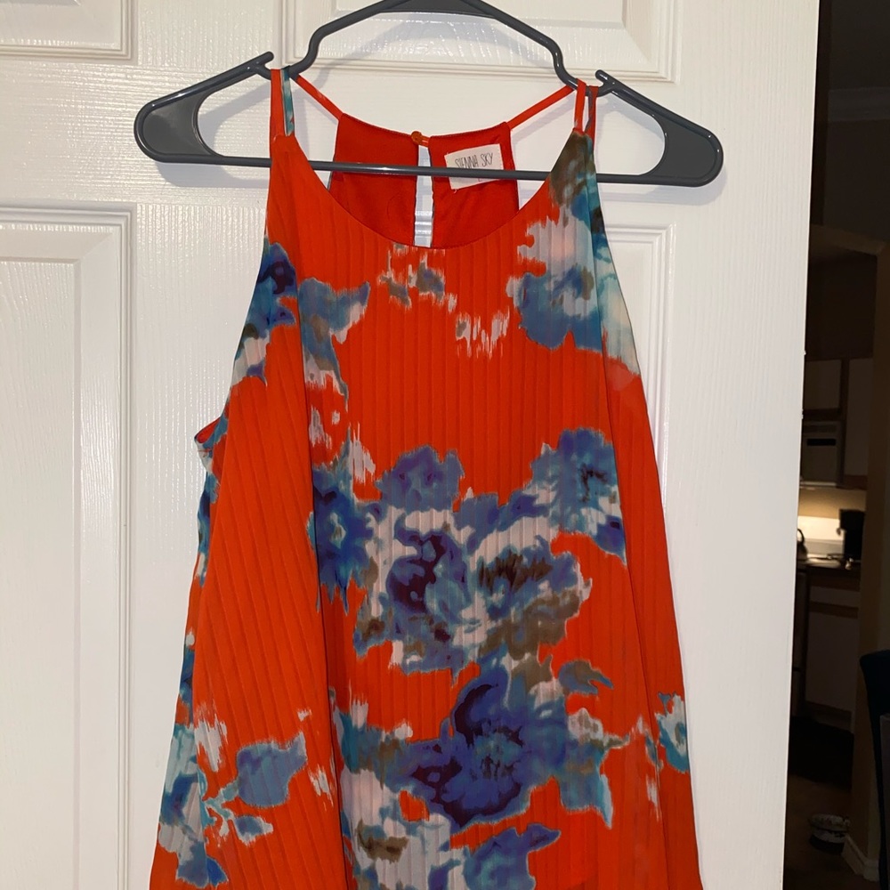 Red blouse with blue and white flowers